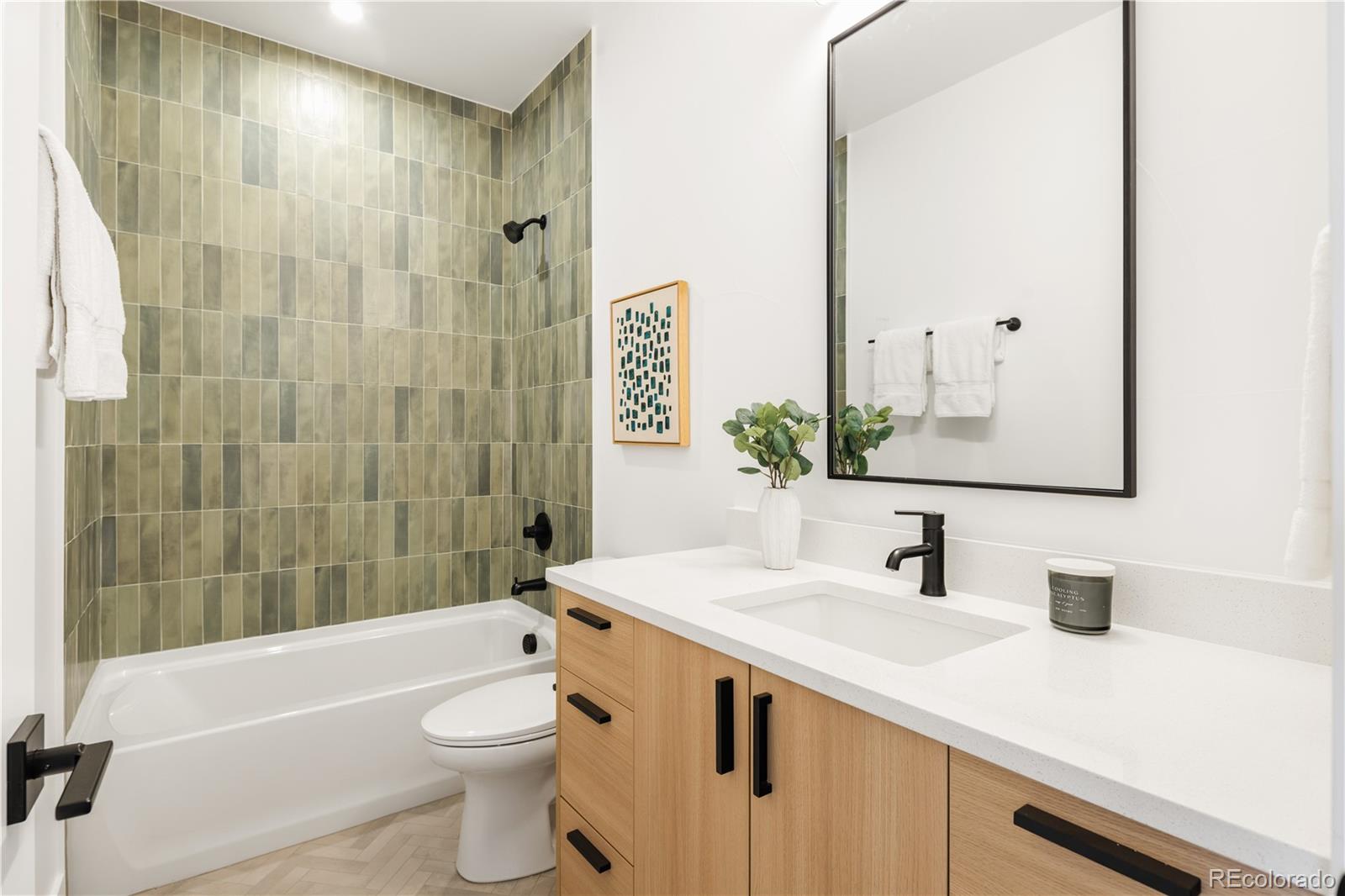1205 Utica Street Denver, CO 80204 - Photo 16 of 35 a bathroom with a sink a toilet and shower