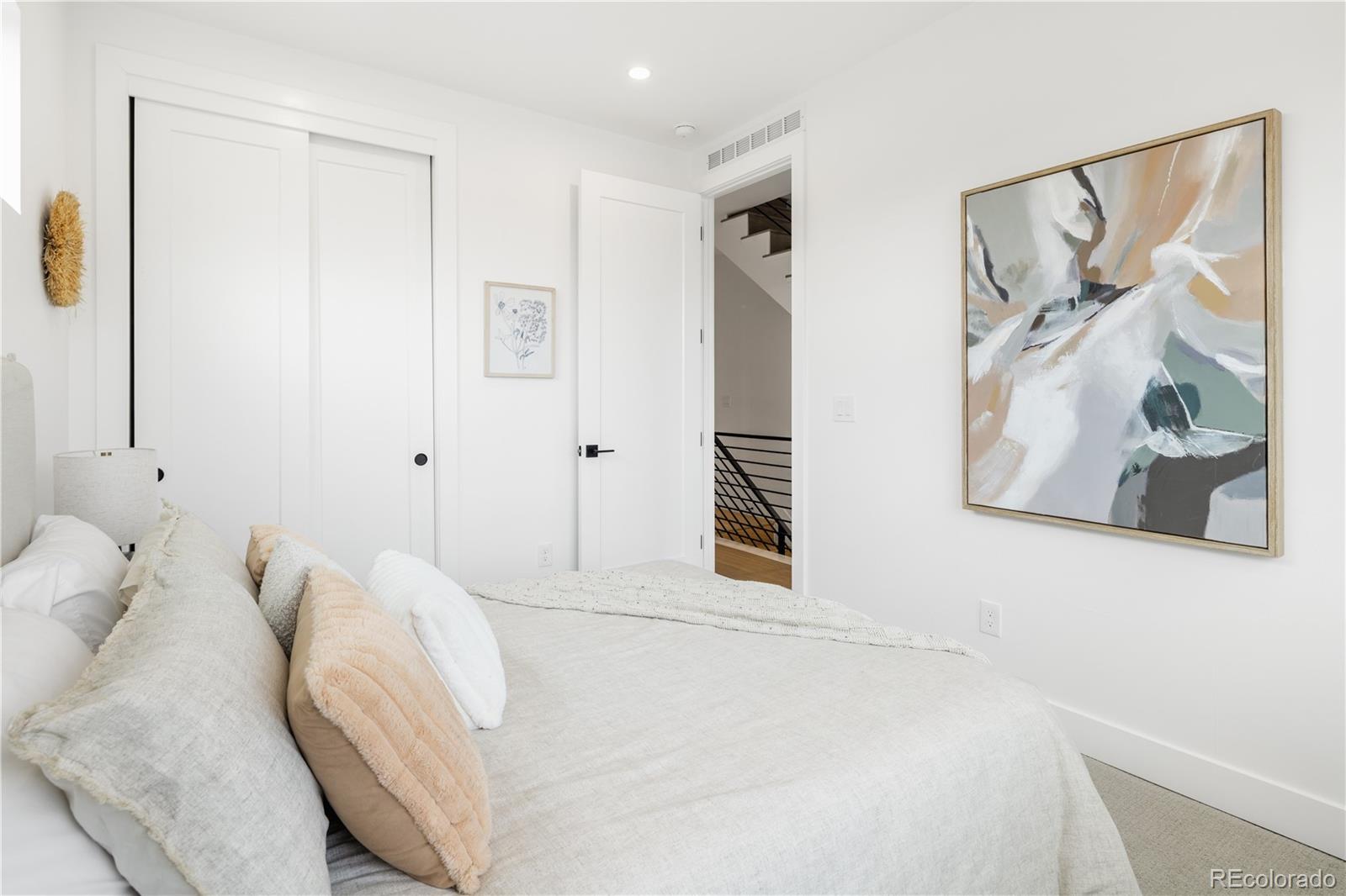 1205 Utica Street Denver, CO 80204 - Photo 18 of 35 a bedroom with a bed and a window