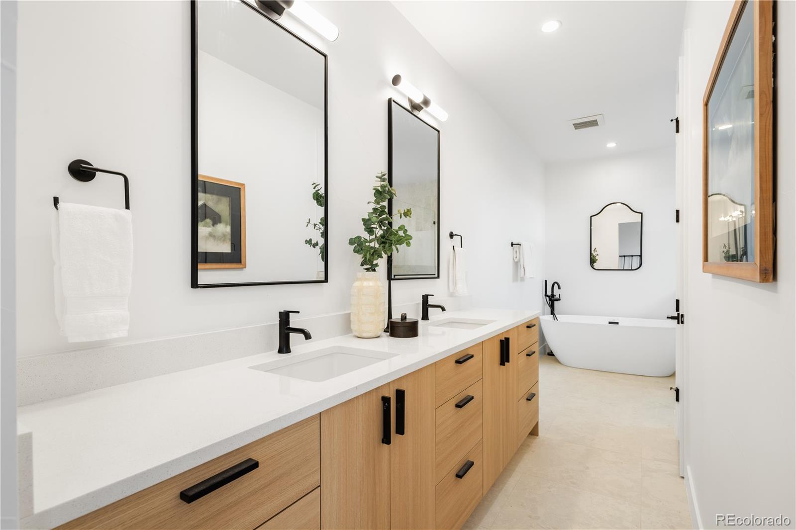 1205 Utica Street Denver, CO 80204 - Photo 23 of 35 a bathroom with a double vanity sink mirror and bathtub