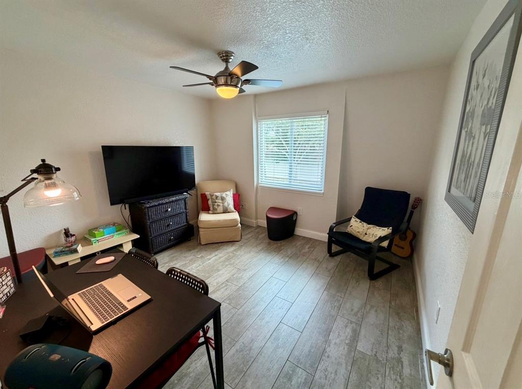 1938 South Conway Road, Unit 7 Orlando, FL 32812 - Photo 17 of 23 a living room with furniture and a flat screen tv