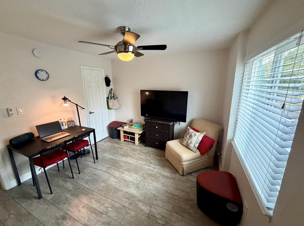 1938 South Conway Road, Unit 7 Orlando, FL 32812 - Photo 18 of 23 a living room with furniture and a flat screen tv