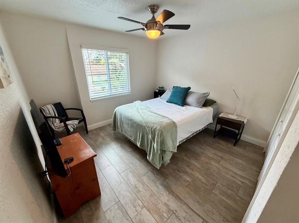 1938 South Conway Road, Unit 7 Orlando, FL 32812 - Photo 19 of 23 a bedroom with a bed a dresser and chair
