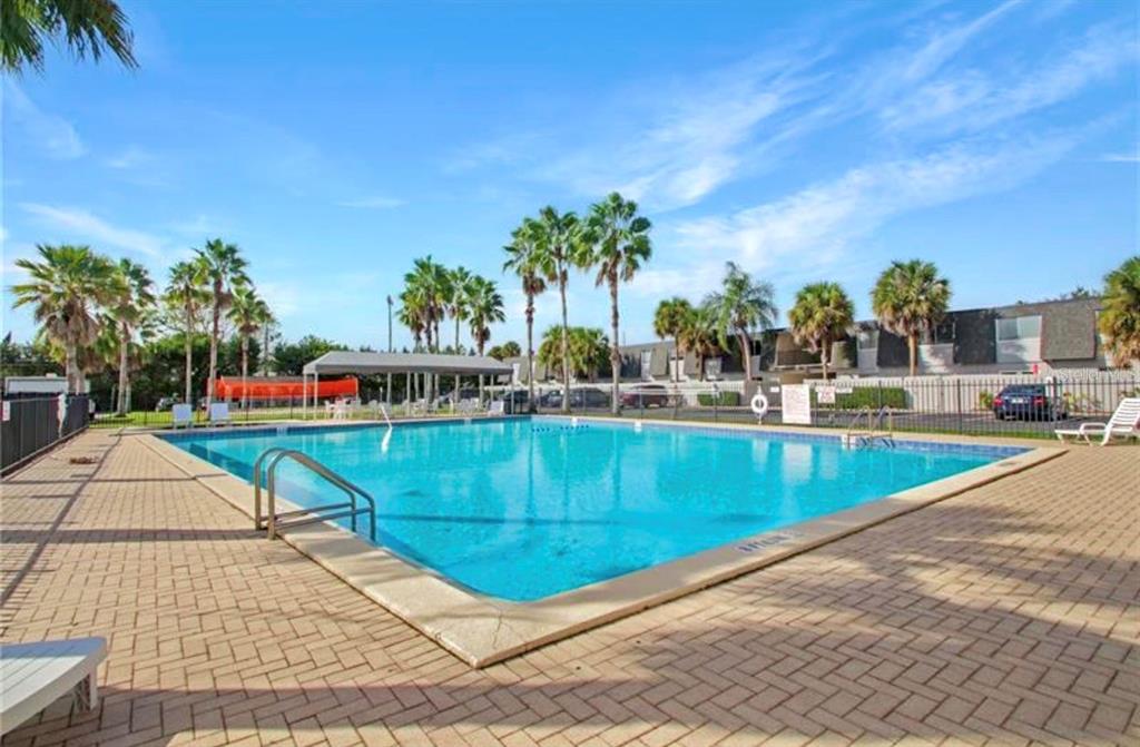 1938 South Conway Road, Unit 7 Orlando, FL 32812 - Photo 23 of 23 a view of a swimming pool with a lounge chairs