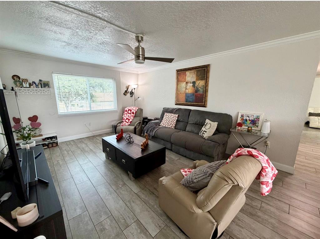 1938 South Conway Road, Unit 7 Orlando, FL 32812 - Photo 3 of 23 a living room with furniture and a wooden floor