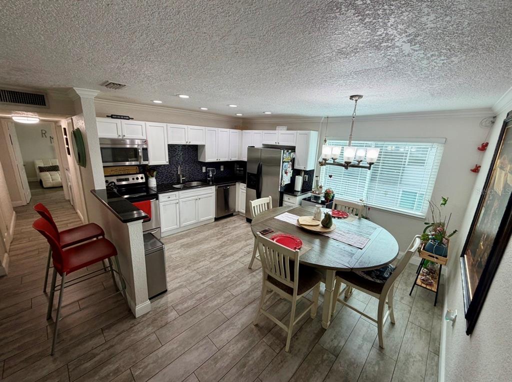 1938 South Conway Road, Unit 7 Orlando, FL 32812 - Photo 9 of 23 a view of a dining room with furniture and wooden floor