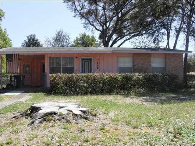 Nice fenced yard with mature trees in back.