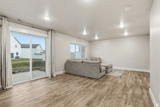 2011 Wren Circle Logan, UT 84339 - Photo 8 of 20 Living area featuring baseboards and light wood-style flooring