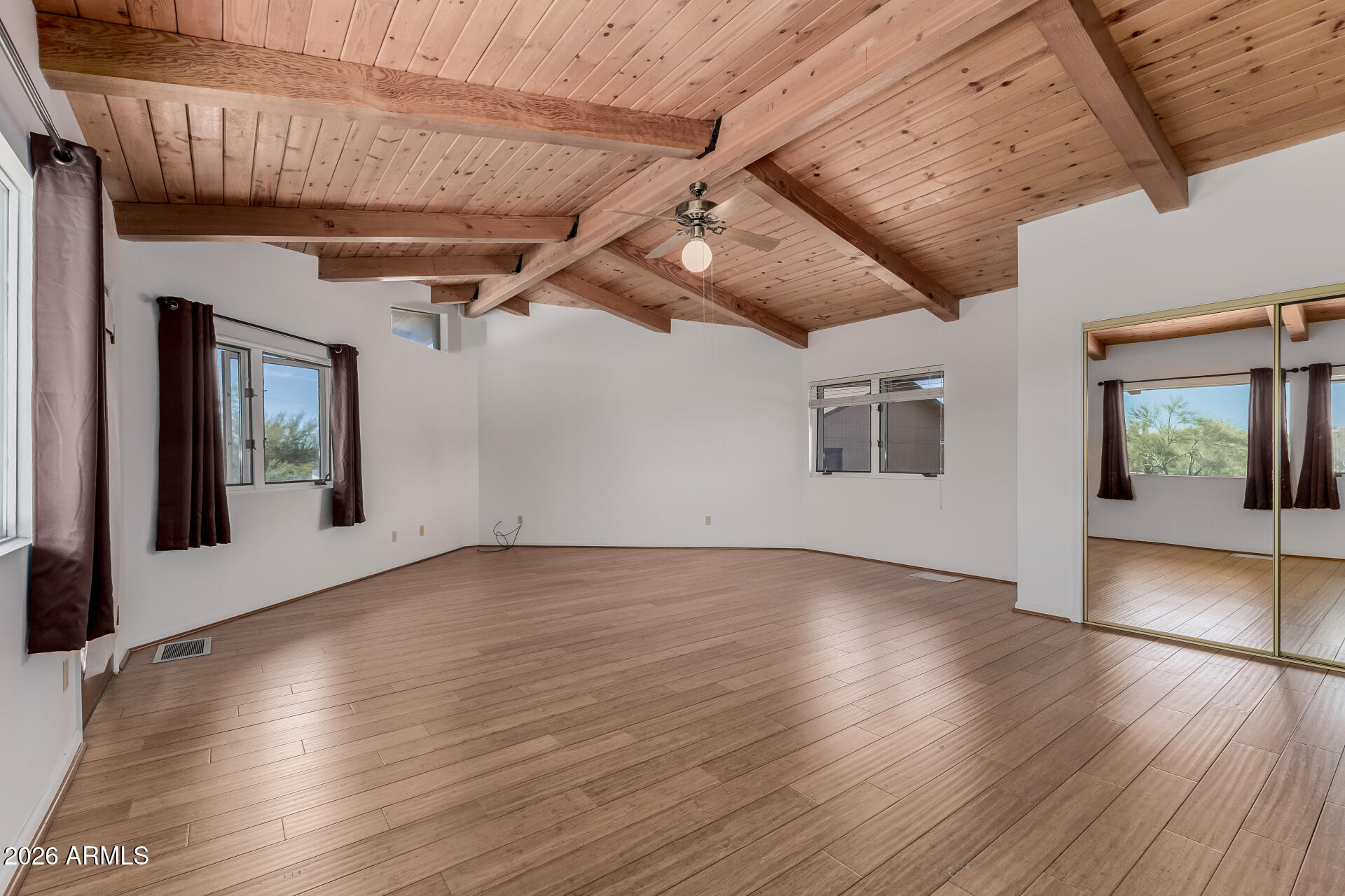 6140 East Peak View Road Cave Creek, AZ 85331 - Photo 13 of 52 a view of an empty room with wooden floor and a window