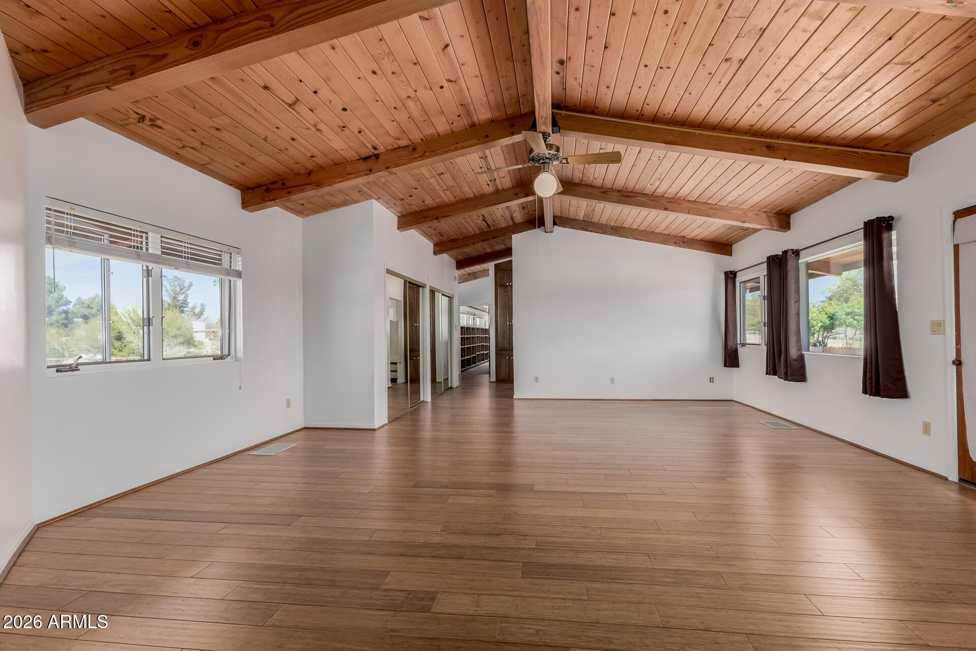 6140 East Peak View Road Cave Creek, AZ 85331 - Photo 14 of 52 a view of an empty room with wooden floor and a window