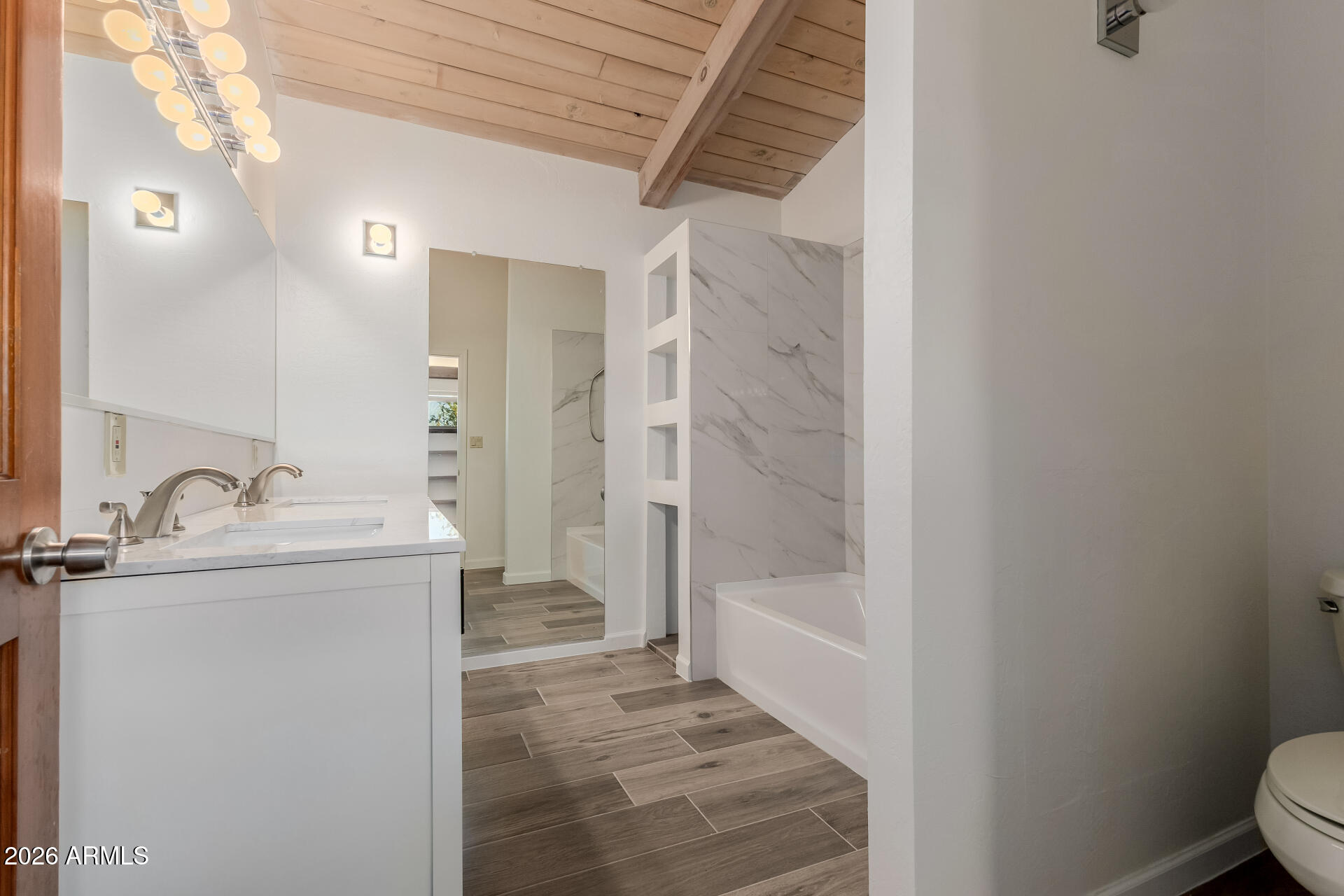 6140 East Peak View Road Cave Creek, AZ 85331 - Photo 22 of 52 a bathroom with a granite countertop sink a toilet and shower