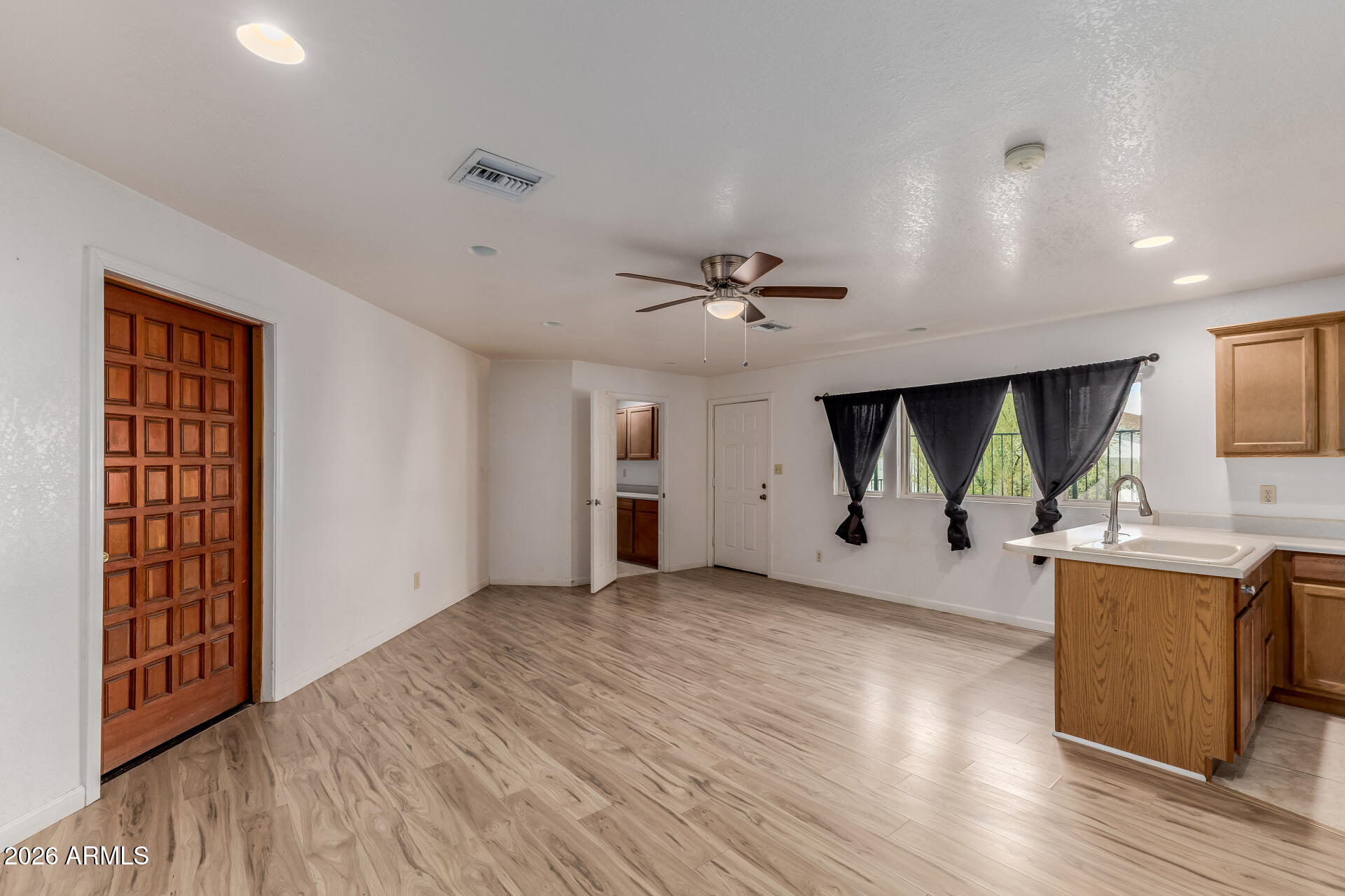 6140 East Peak View Road Cave Creek, AZ 85331 - Photo 24 of 52 a view of a kitchen with a sink wooden floor and a window