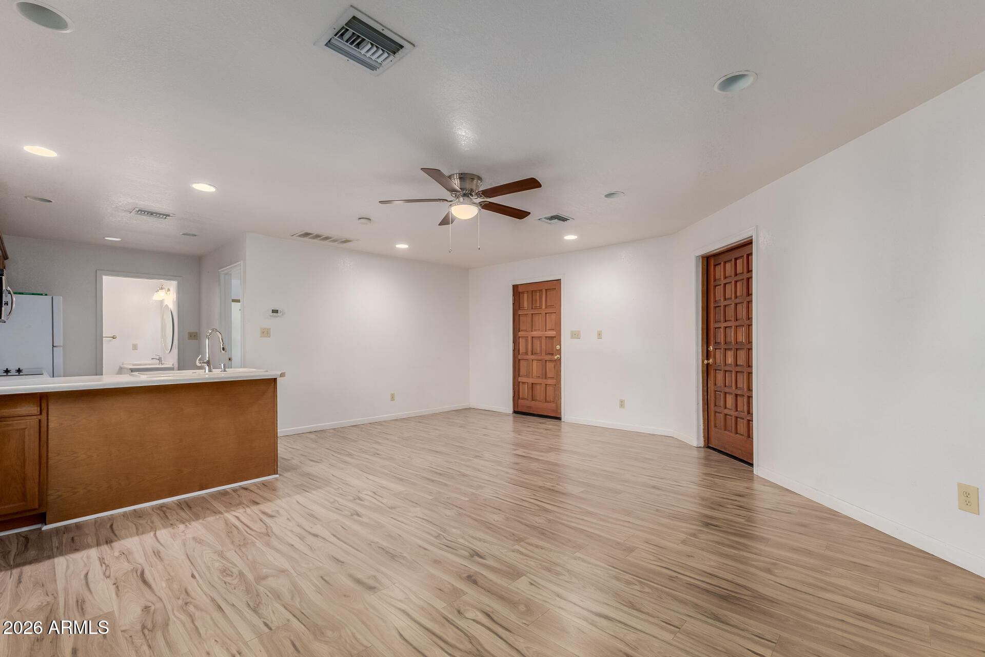 6140 East Peak View Road Cave Creek, AZ 85331 - Photo 25 of 52 a view of an empty room with wooden floor and a ceiling fan