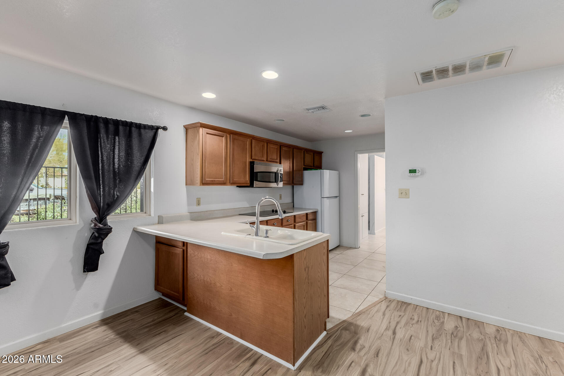 6140 East Peak View Road Cave Creek, AZ 85331 - Photo 27 of 52 a kitchen with sink refrigerator and window