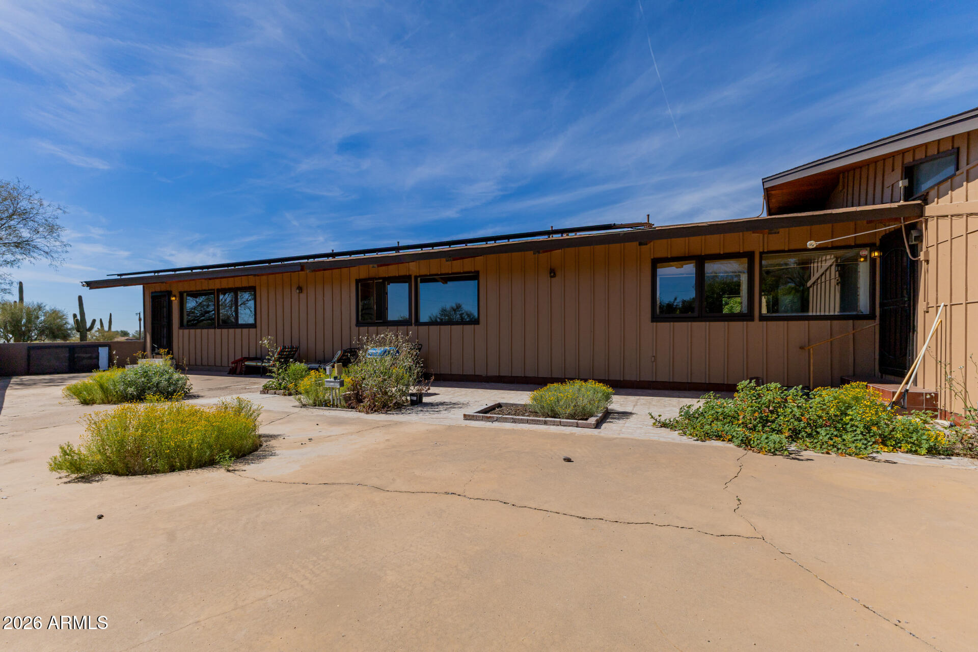6140 East Peak View Road Cave Creek, AZ 85331 - Photo 41 of 52 a front view of a house with garden and plants