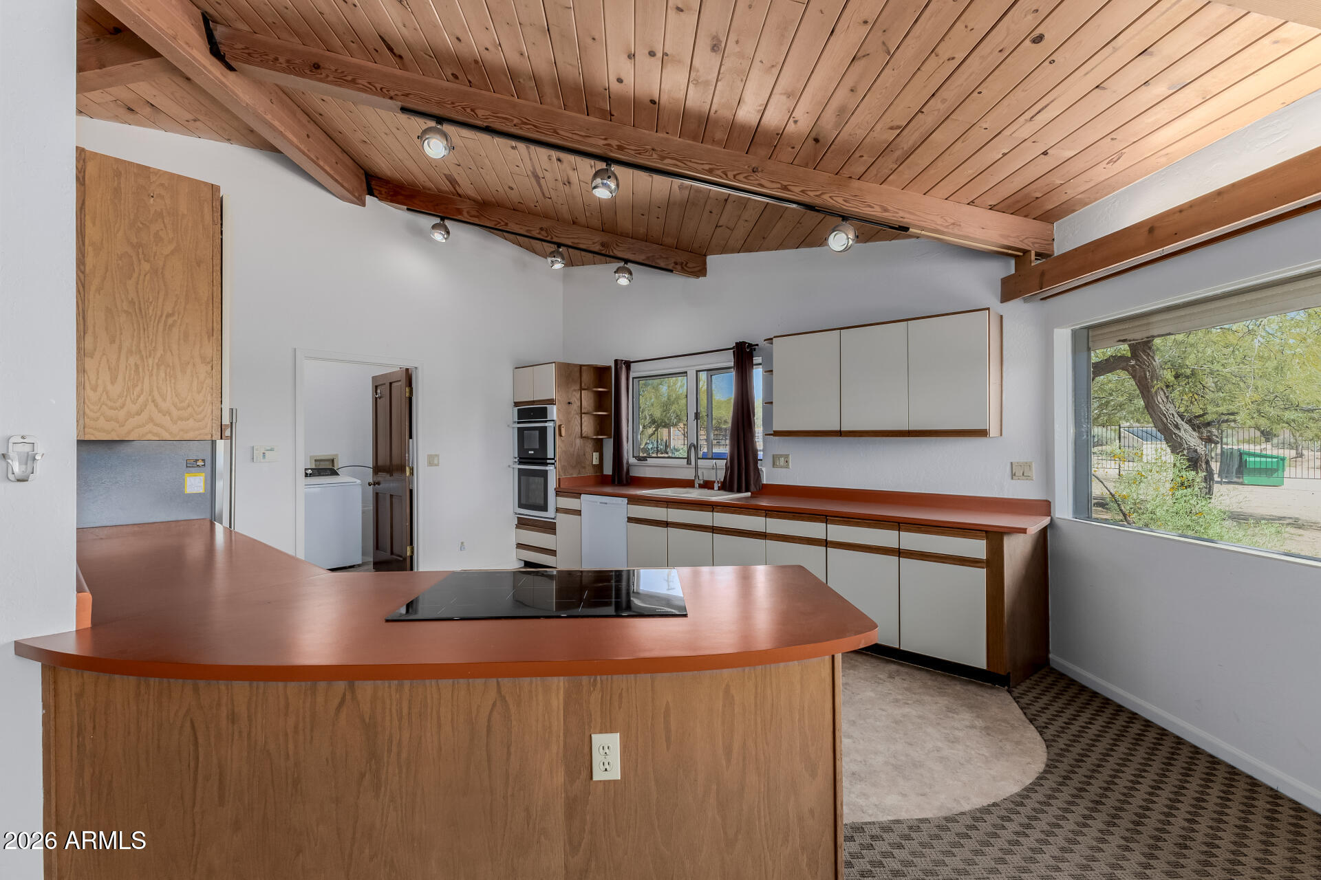 6140 East Peak View Road Cave Creek, AZ 85331 - Photo 8 of 52 a kitchen with stainless steel appliances granite countertop a sink window and cabinets