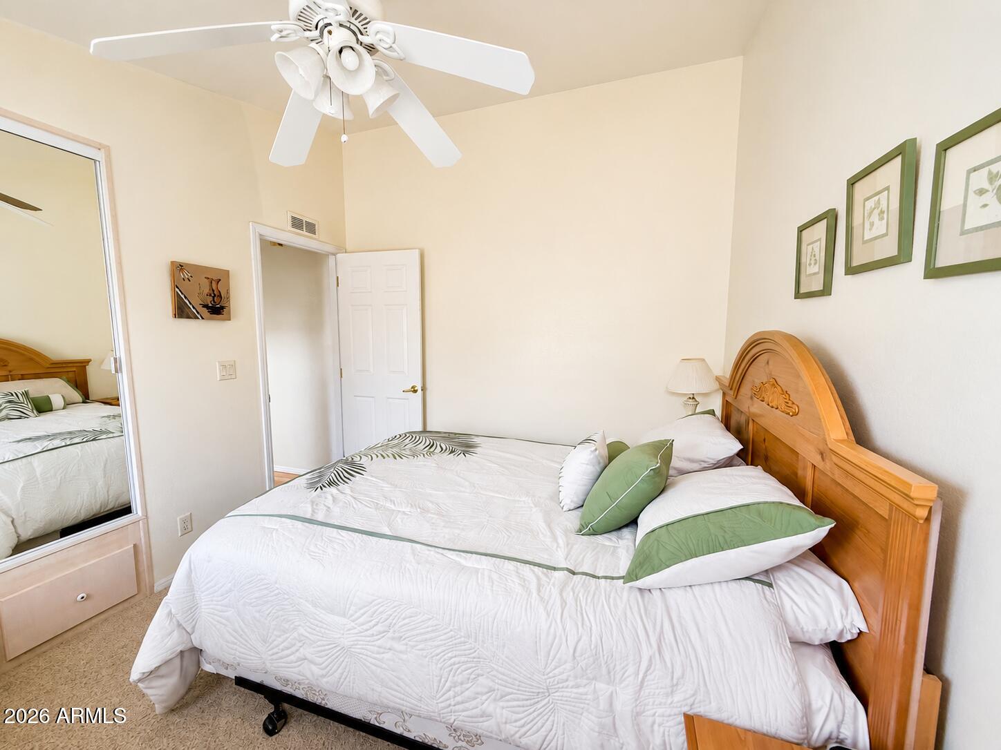 8865 East Baseline Road, Unit 103 Mesa, AZ 85209 - Photo 25 of 47 a bedroom with a bed and a chandelier