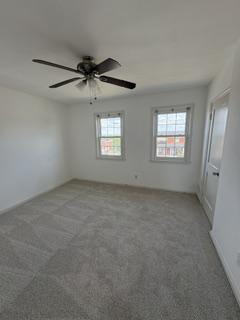 7007 Bank Street Baltimore, MD 21224 - Photo 9 of 17 an empty room with windows and ceiling fan view