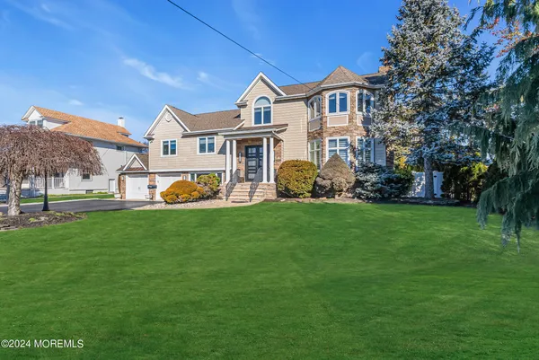 a view of a house with a yard and a garden