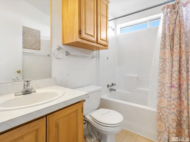 a view of a house with a car parked in front of it