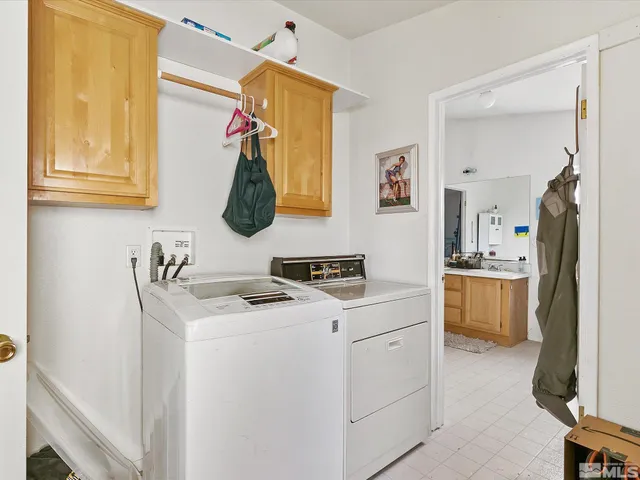 a bedroom with a bed a couch and dresser