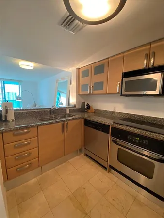 a kitchen with a sink and a stove