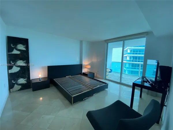 a living room with furniture rug and lamp