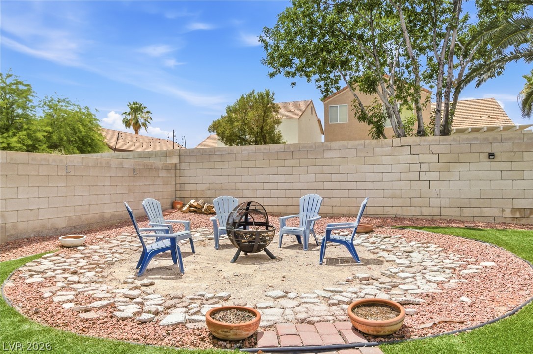 9523 Observer Street Las Vegas, NV 89123 - Photo 40 of 42 An inviting backyard fire pit area offers a delightful spot for outdoor gatherings.