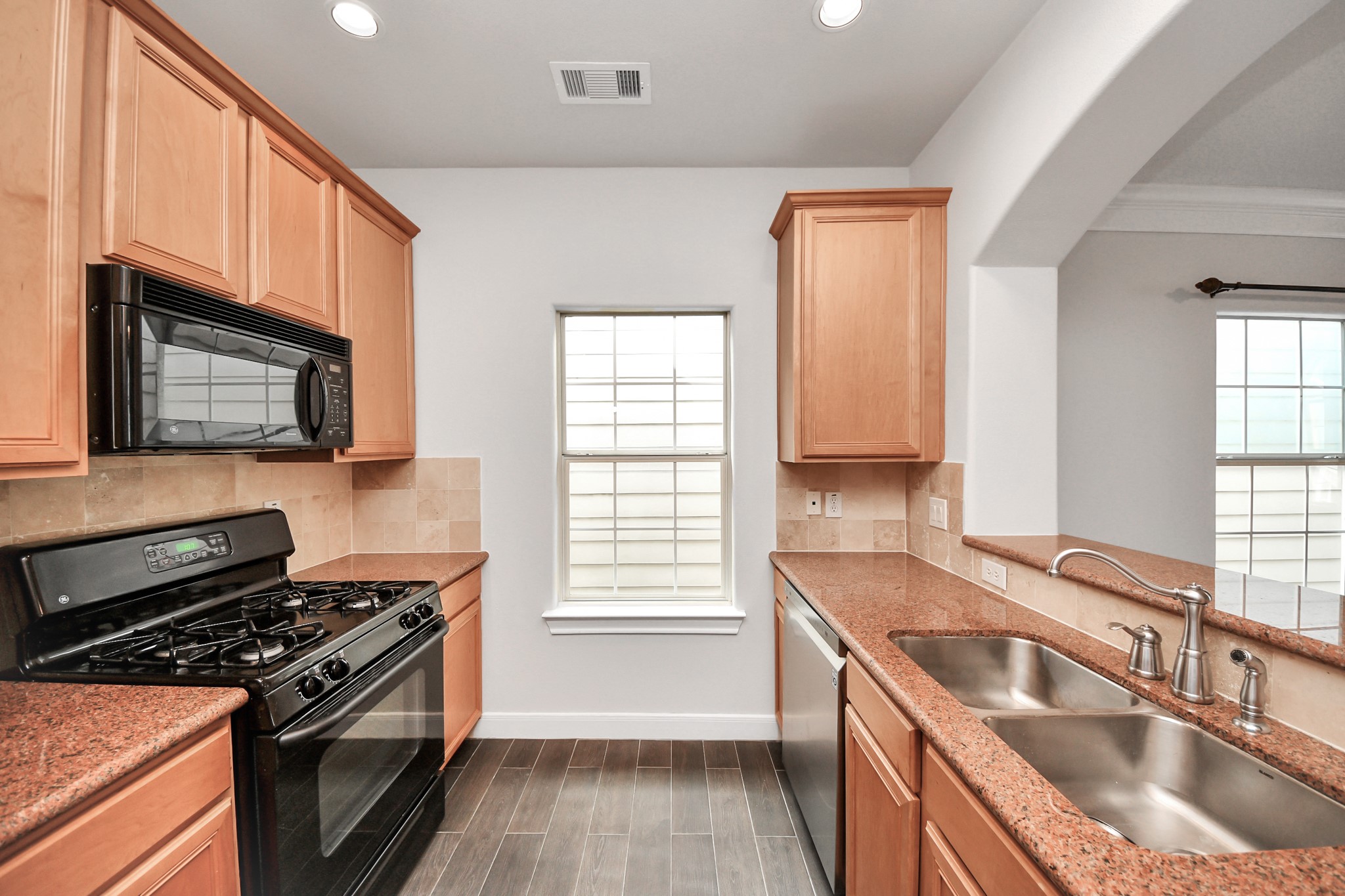 2941 Clinton Drive Houston, TX 77020 - Photo 12 of 35 a kitchen that has a sink wooden floor and a stove top oven