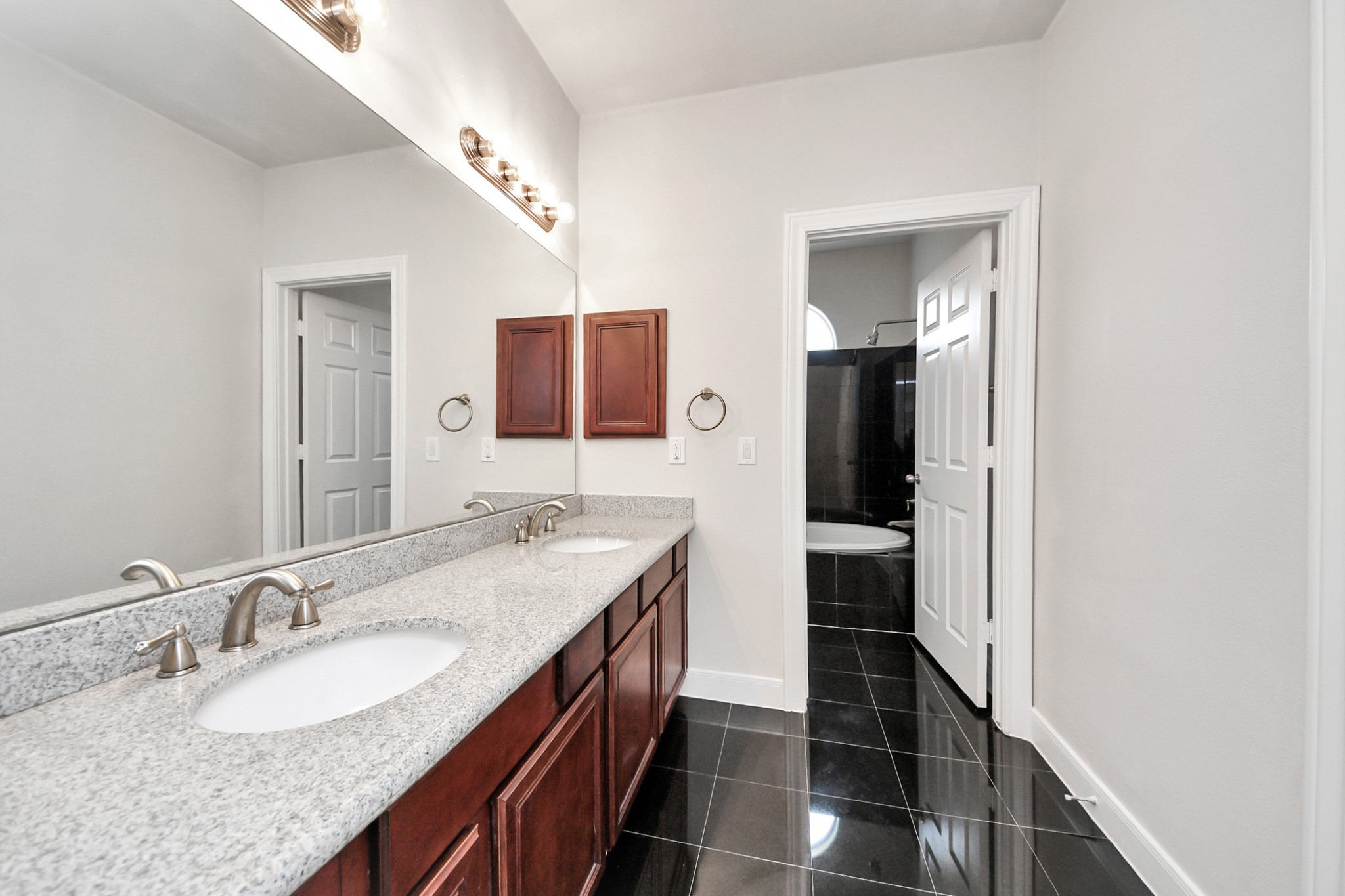 2941 Clinton Drive Houston, TX 77020 - Photo 21 of 35 a bathroom with a granite countertop double vanity sink and a mirror