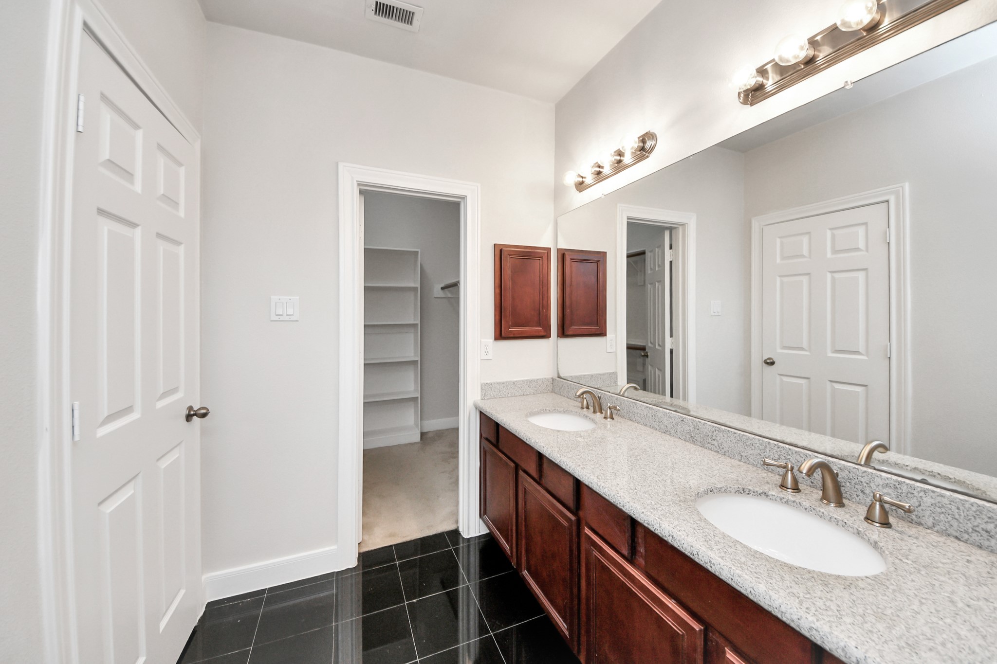 2941 Clinton Drive Houston, TX 77020 - Photo 23 of 35 a bathroom with a double vanity sink and mirror