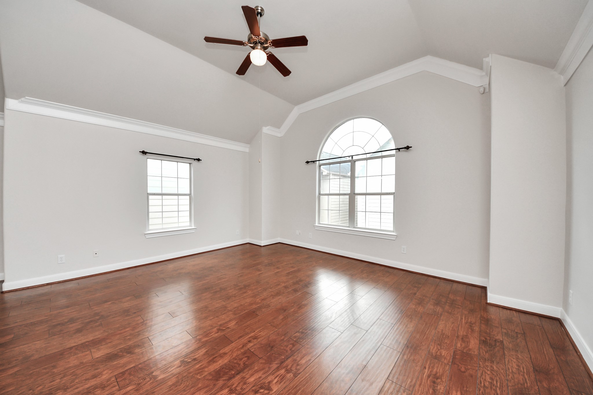 2941 Clinton Drive Houston, TX 77020 - Photo 6 of 35 an empty room with wooden floor fan and windows