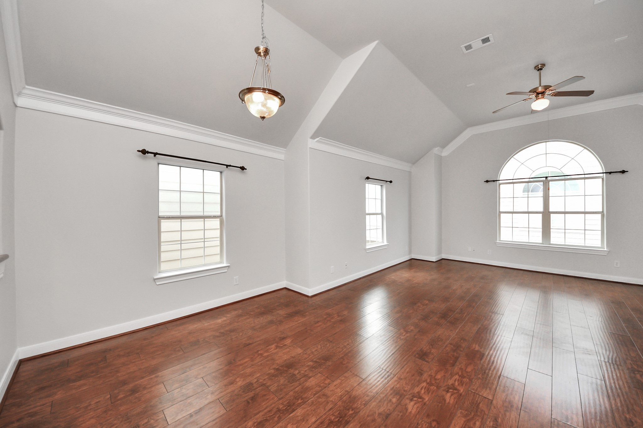 2941 Clinton Drive Houston, TX 77020 - Photo 7 of 35 an empty room with wooden floor chandelier and windows