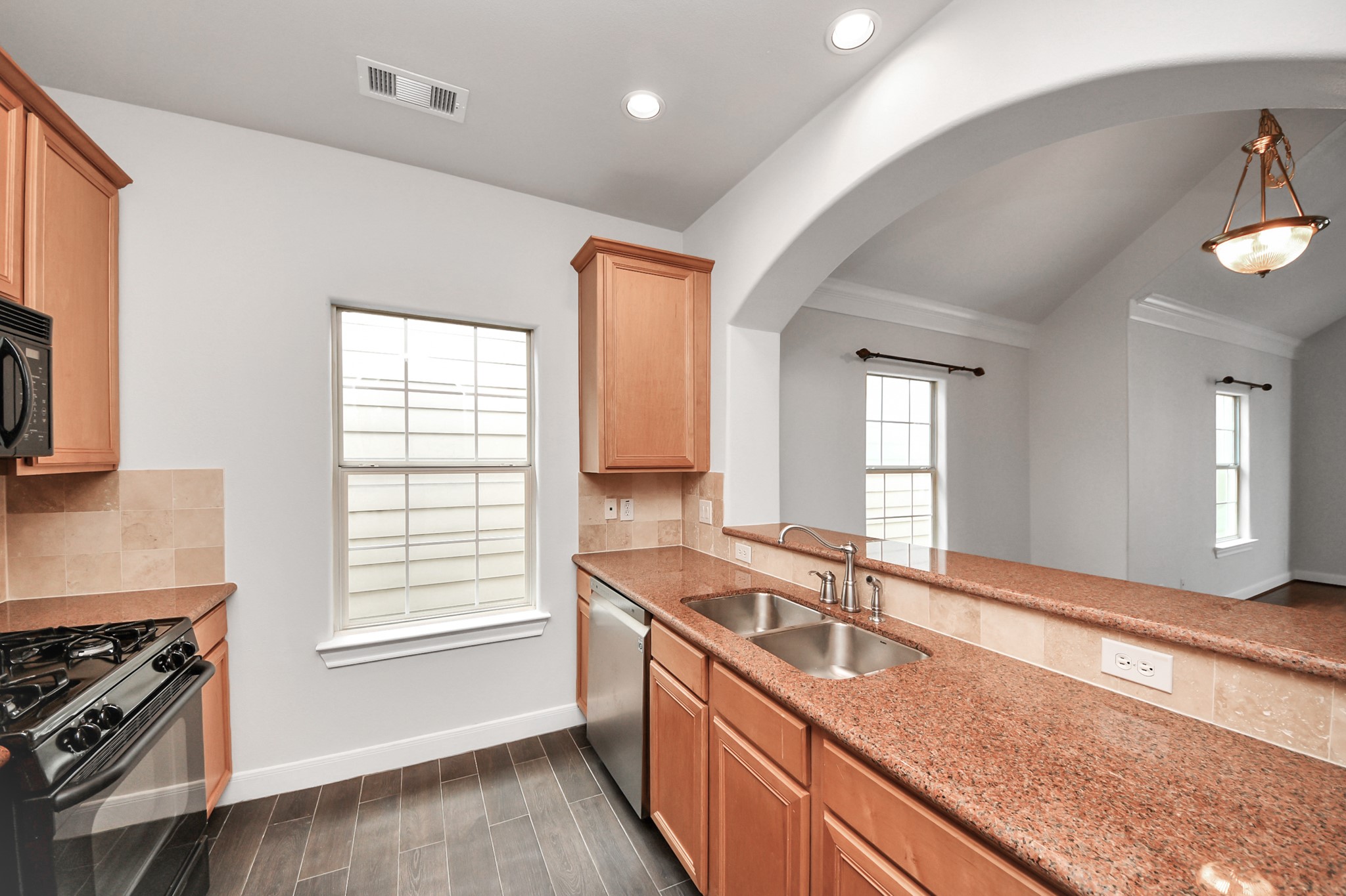 2941 Clinton Drive Houston, TX 77020 - Photo 8 of 35 a kitchen with granite countertop a sink stove and cabinets
