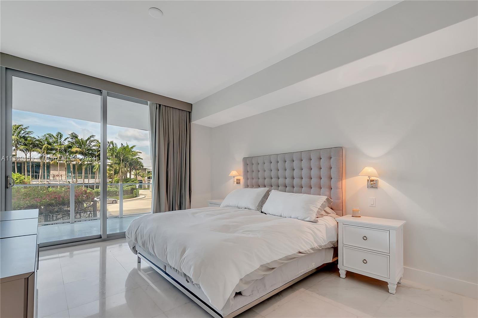 360 Ocean Drive, Unit 205S Key Biscayne, FL 33149 - Photo 11 of 27 a bedroom with a large bed and a large window