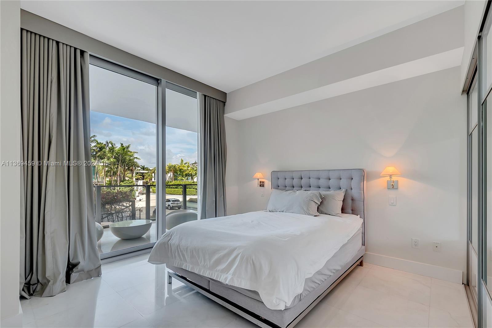 360 Ocean Drive, Unit 205S Key Biscayne, FL 33149 - Photo 15 of 27 a bedroom with a large bed and a large window