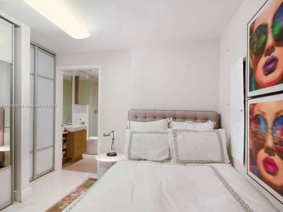 360 Ocean Drive, Unit 205S Key Biscayne, FL 33149 - Photo 17 of 27 a bedroom with a bed and painting on the wall