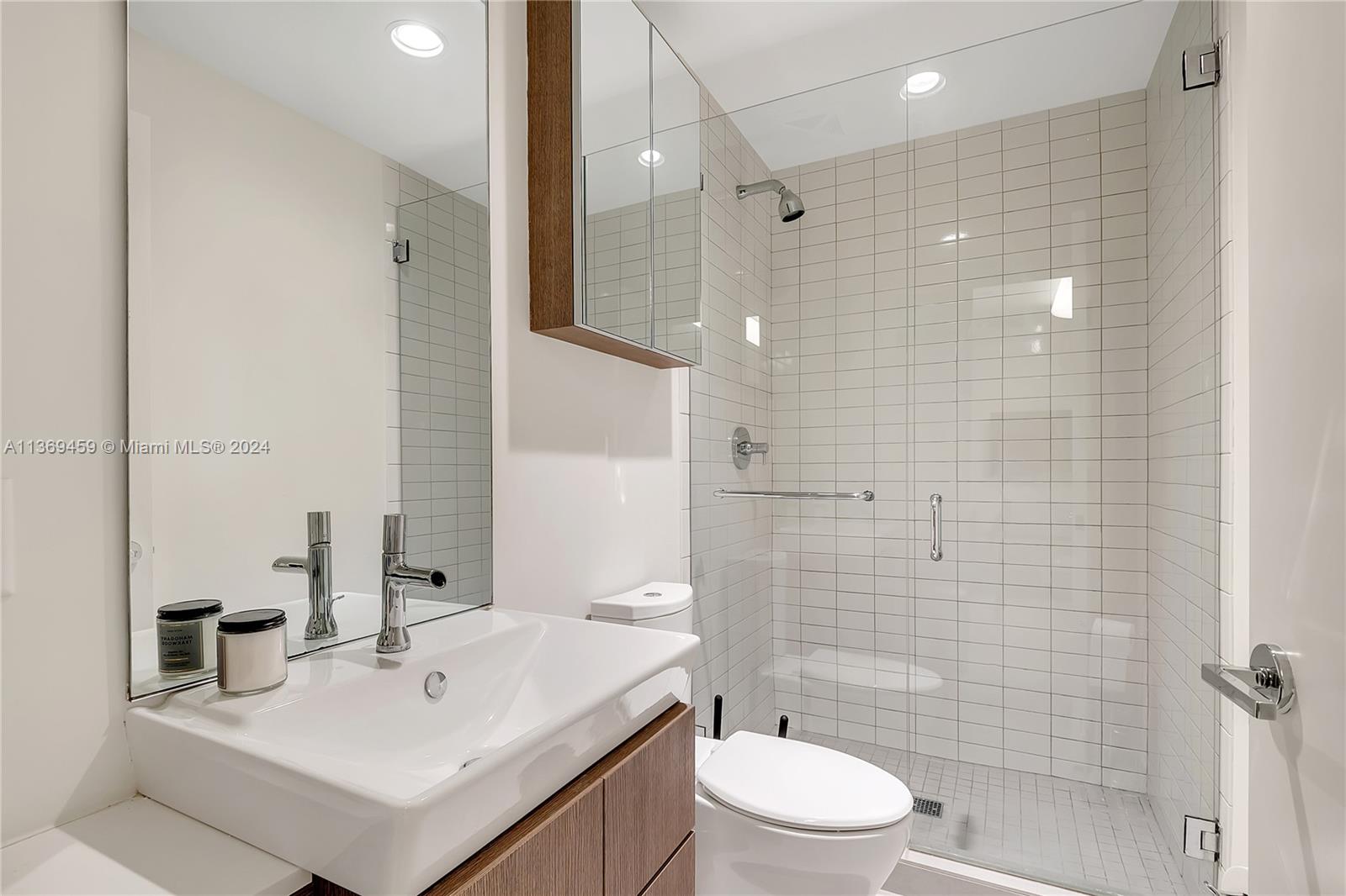 360 Ocean Drive, Unit 205S Key Biscayne, FL 33149 - Photo 19 of 27 a bathroom with a sink toilet and shower