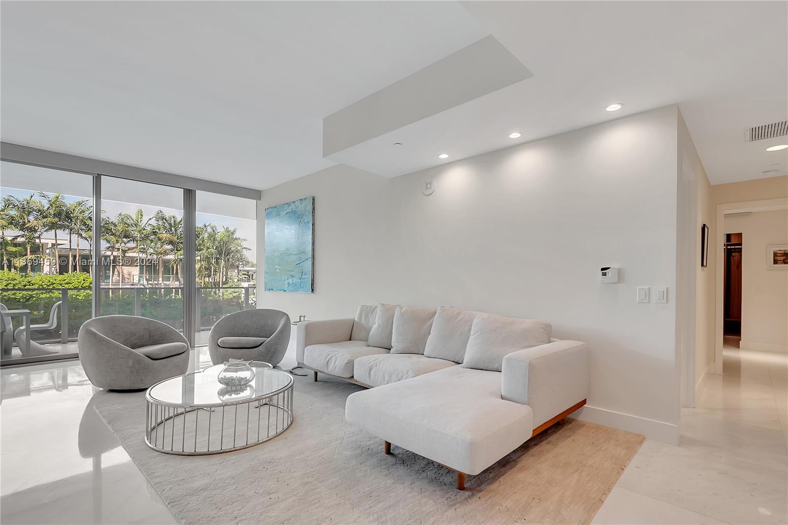 360 Ocean Drive, Unit 205S Key Biscayne, FL 33149 - Photo 5 of 27 a living room with furniture and a large window