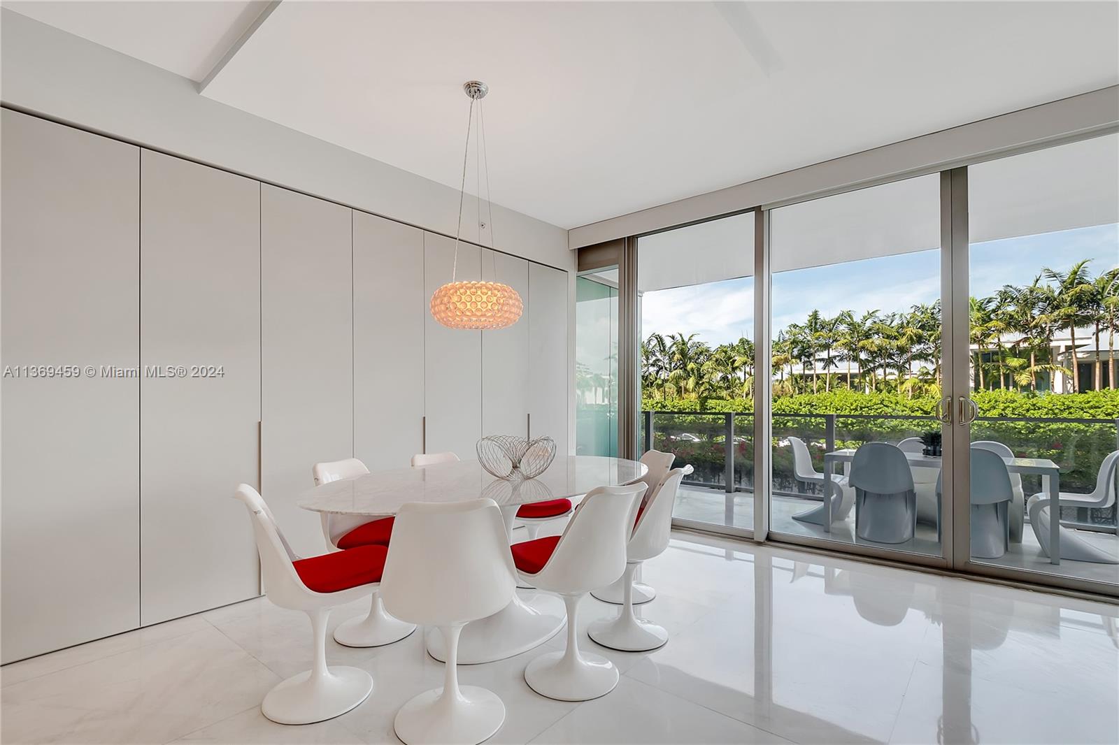 360 Ocean Drive, Unit 205S Key Biscayne, FL 33149 - Photo 6 of 27 a dining room with furniture and a floor to ceiling window