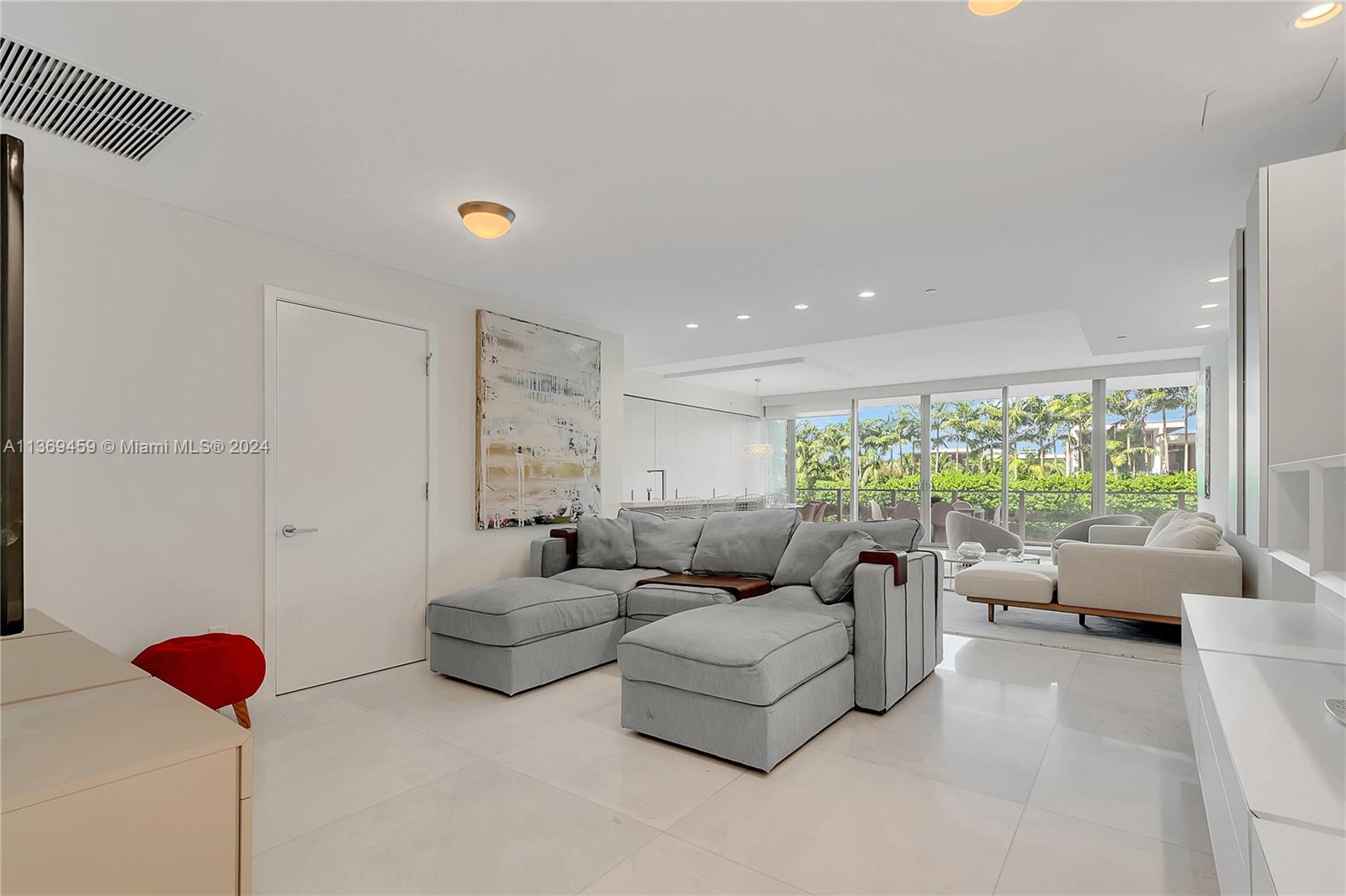 360 Ocean Drive, Unit 205S Key Biscayne, FL 33149 - Photo 9 of 27 a living room with furniture and a large window