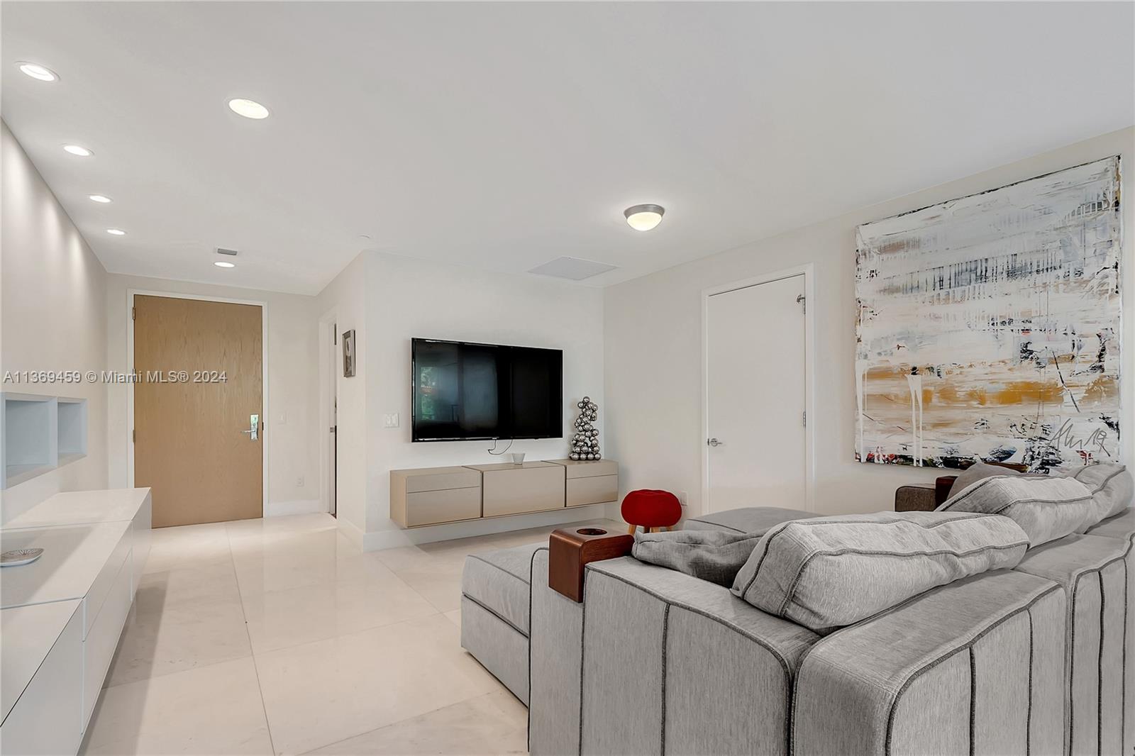 360 Ocean Drive, Unit 205S Key Biscayne, FL 33149 - Photo 10 of 27 a bedroom with furniture and a flat screen tv