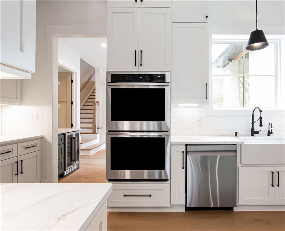 3286 Elwin Ragsdale Way Acworth, GA 30102 - Photo 20 of 51 a kitchen with stainless steel appliances a stove a microwave and a sink