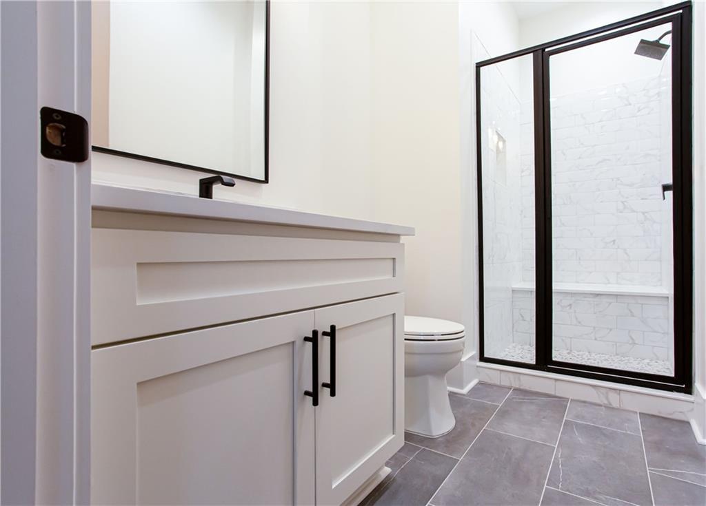 3286 Elwin Ragsdale Way Acworth, GA 30102 - Photo 28 of 51 a bathroom with a toilet a sink and mirror