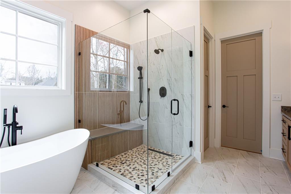 3286 Elwin Ragsdale Way Acworth, GA 30102 - Photo 37 of 51 a bathroom with a tub shower and a sink