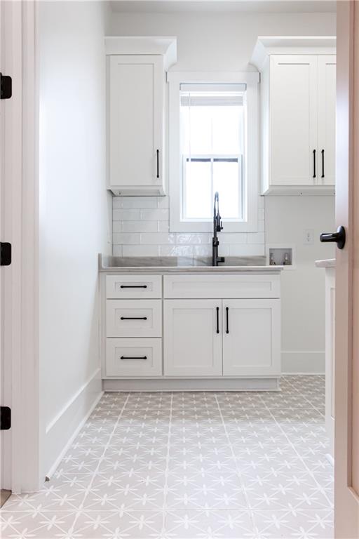 3286 Elwin Ragsdale Way Acworth, GA 30102 - Photo 41 of 51 a kitchen with granite countertop white cabinets and white appliances