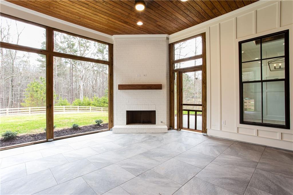 3286 Elwin Ragsdale Way Acworth, GA 30102 - Photo 10 of 51 a view of an empty room with a fireplace and windows