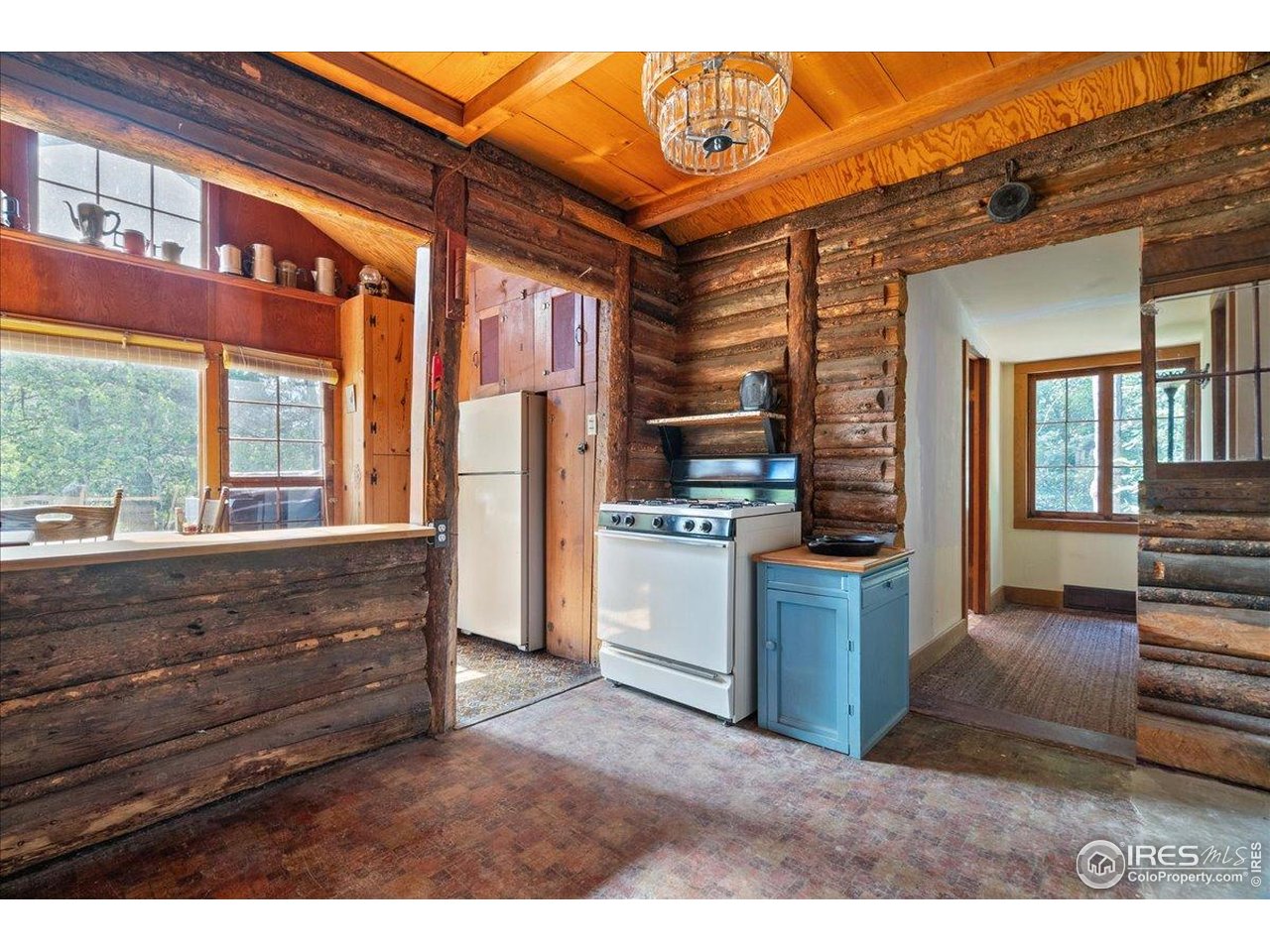 49 Riverside Drive Lyons, CO 80540 - Photo 13 of 32 a kitchen view with granite countertop a stove and a refrigerator
