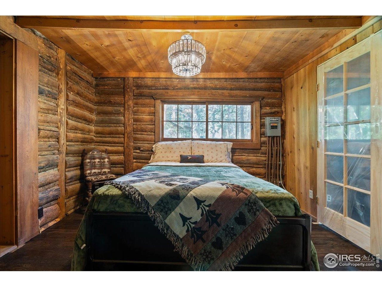 49 Riverside Drive Lyons, CO 80540 - Photo 19 of 32 a bedroom with a bed and a window