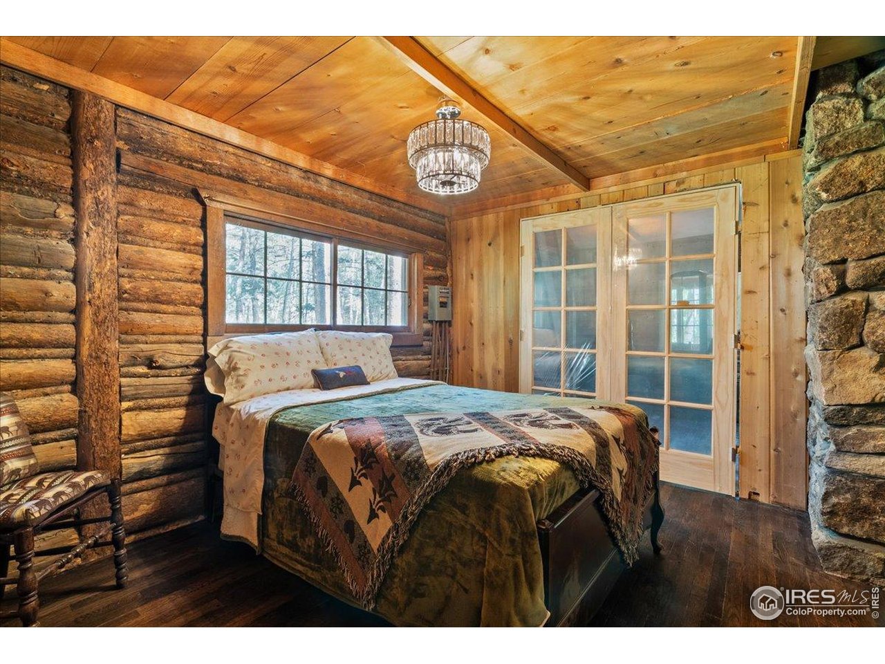 49 Riverside Drive Lyons, CO 80540 - Photo 20 of 32 a bed sitting in a bedroom next to a window