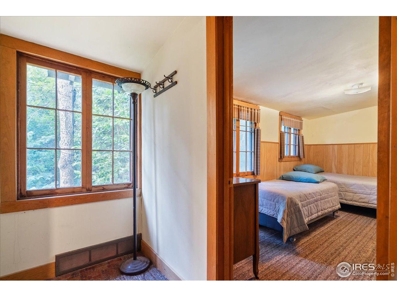49 Riverside Drive Lyons, CO 80540 - Photo 22 of 32 a bedroom with a bed and wooden floor